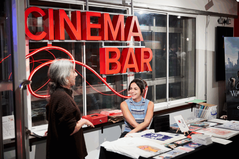 Safaa and Beth selling Submit to Love products at our film screening at Rich Mix